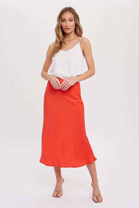 Satin midi skirt in coral with hidden side zipper, size small to large.