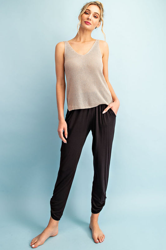 Black pants with shirring at waist and ankles, size small to large.