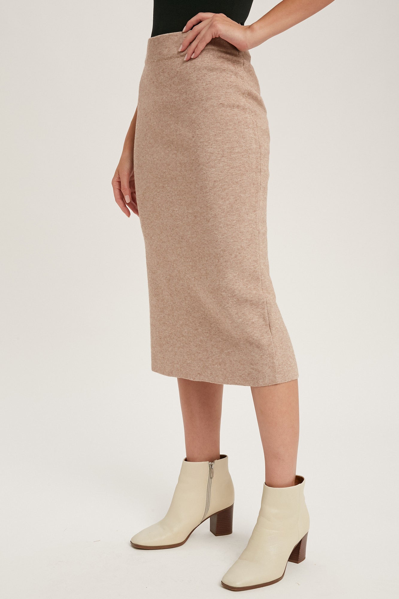 Latte colored knit skirt with slit in the back, size small to large.