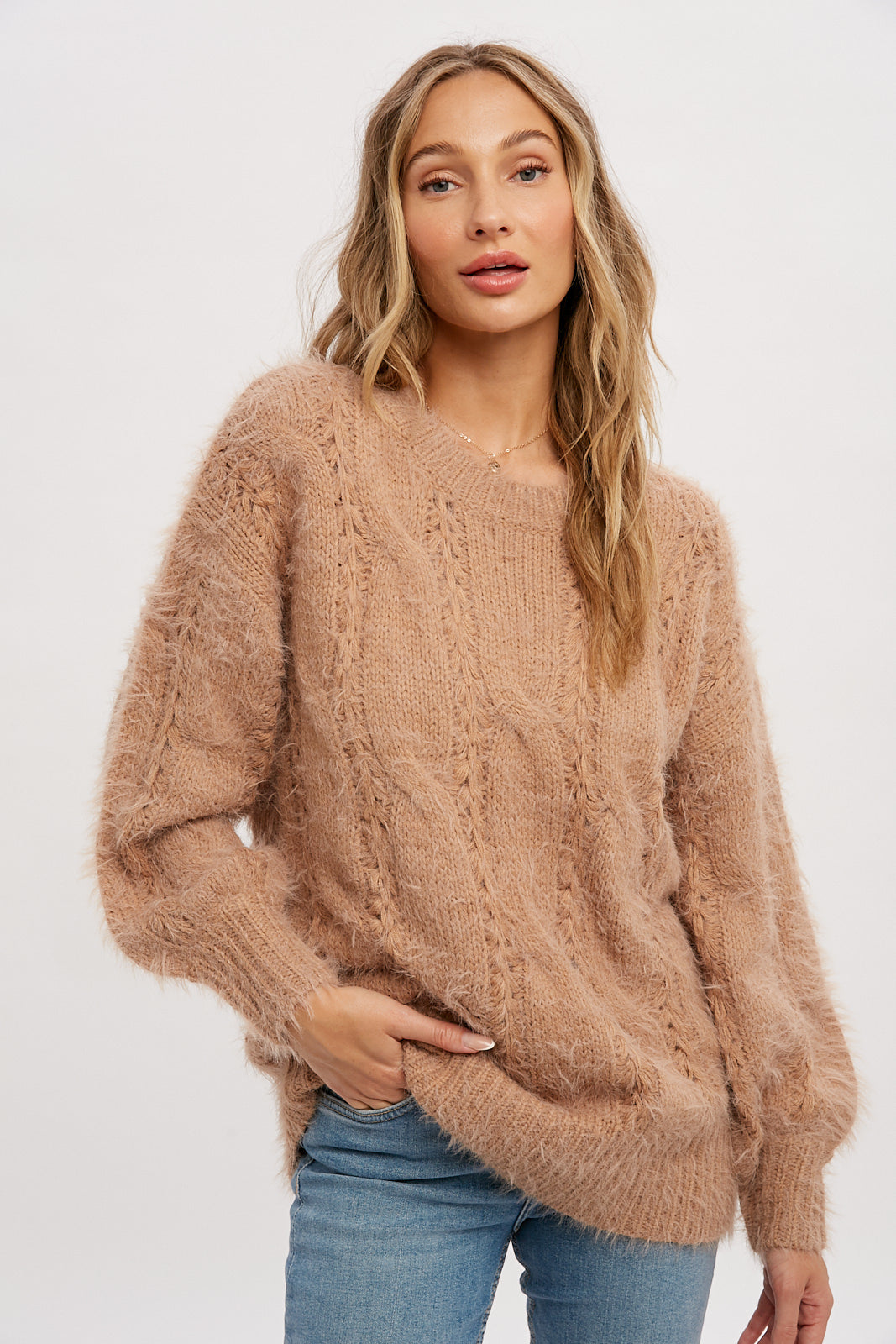 Tunic style sweater with long sleeves, ribbed hem and cuffs, soft material, size small medium and medium large.